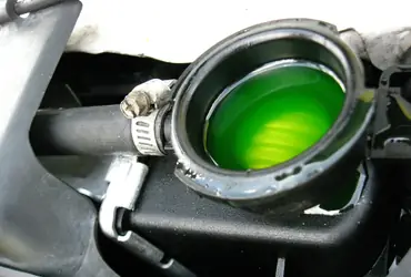 Green or orange puddle under the car